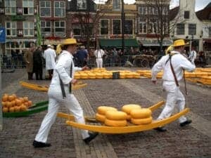 two traditonal cheese makers transporting dutch cheese to the cheese market of Alkmaar