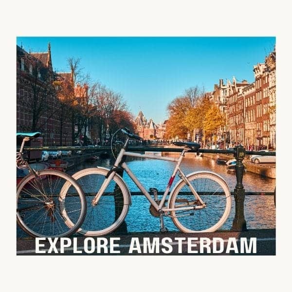 picture of an amsterdam canal with a bike parked on a bridge