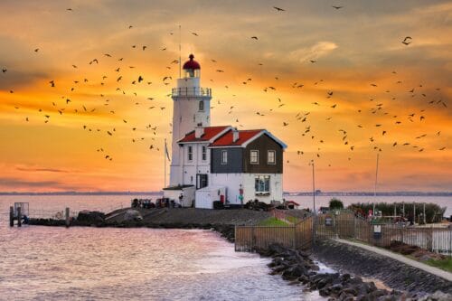 a lighthouse at the Zuiderzee near Marken in the sunset