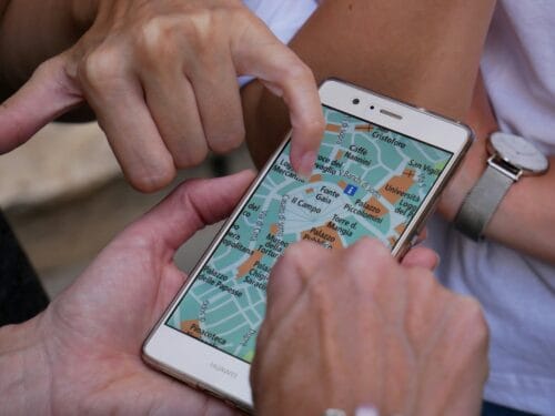 hands on a phone map trying to find the right direction