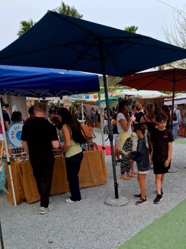 People standing in front of a marketstall in Ibiza