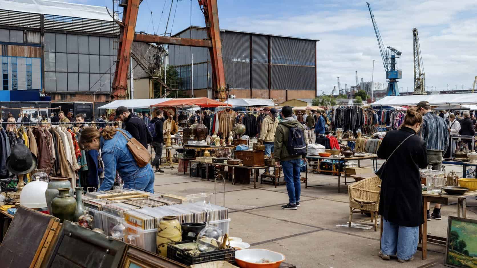 Some vintage stalls and visitors of the IJ-hallen at the NDSM warf in Amsterdam